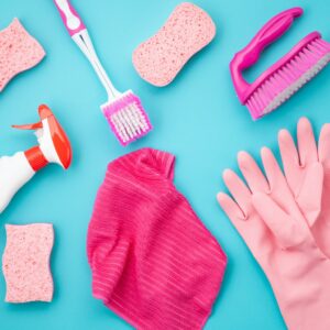 Detergents and cleaning accessories in pastel color. Cleaning service, small business idea. Top view